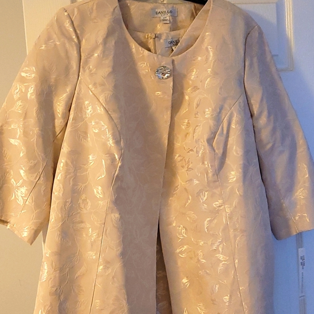 I'm selling a 2 pc dress that is tan in color. The material is soft and light.